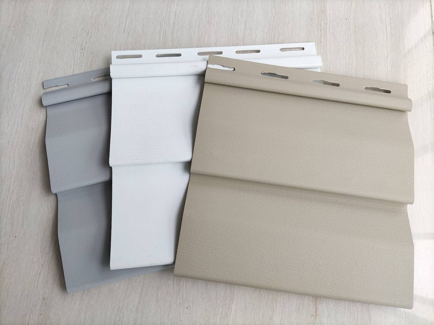 Pure Colour Collection White, grey and warm neutral siding colour options with a subtle wood-grain surface by Home Plus Materials